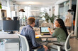 © Alvaro Lavin/Stocksy - Coworkers sharing statistics on laptop in modern office