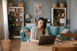 © Mihajlo Ckovric/Stocksy - Focused Woman Working on Laptop at Cozy Home Office Desk