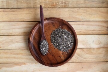 Wall Mural - Chia seeds on brown wood background