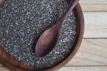 Wall Mural - Chia seeds on brown wood background