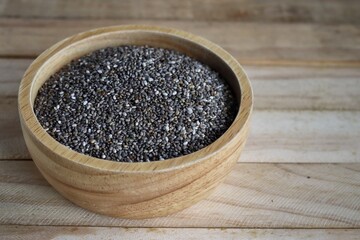 Wall Mural - Chia seeds on brown wood background