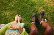 © Javier Díez/Stocksy - Anonymous friends sitting on green grass