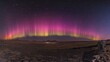 © Almahyra - Vibrant aurora borealis display over a dark, flat landscape at night.