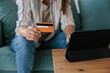 © Mihajlo Ckovric/Stocksy - Woman Using a Tablet for Online Shopping with a Credit Card
