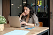 © Santi Nuñez/Stocksy - Focused businesswoman working on laptop in modern office