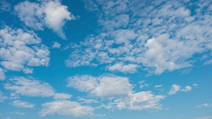 Wall Mural - Blue sky with fluffy cloud time lapse on a sunny day 4k footage.