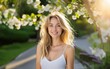 © Volodymyr - Happy woman portrait outdoor. Spring blossom background. Portrait of beautiful smiling woman with flowers. Woman face. Perfect natural skin.