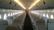 © Nataliia - Empty airplane cabin with rows of white leather seats, spacious overhead compartments, and soft interior lighting, creating a clean and modern travel atmosphere