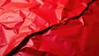 © yuwaree - Crumpled aluminum foil in red color with crack folded on the ground, damaged, broken