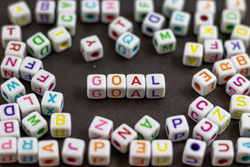 Fototapete - A cluster of colorful letter cubes surrounds the word 