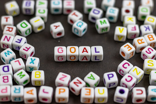 A cluster of colorful letter cubes surrounds the word 