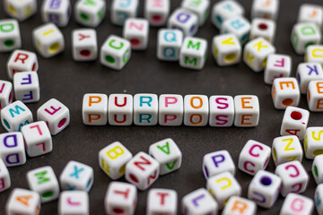Fototapete - A cluster of colorful letter cubes surrounds the word 