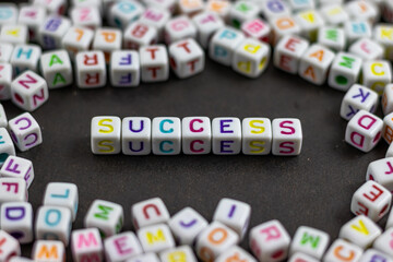 Fototapete - A cluster of colorful letter cubes surrounds the word 