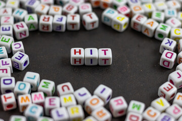 Fototapete - A cluster of colorful letter cubes surrounds the word 