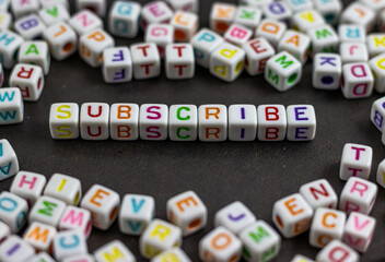 Fototapete - A cluster of colorful letter cubes surrounds the word 