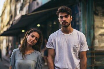 Wall Mural - A man and a woman are standing in front of a building