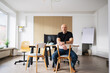 © contrastwerkstatt - Entrepreneur sitting in modern workspace