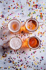 Aufkleber - Four beer mugs celebrating with colorful confetti on table