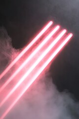 Poster - Soft beams of red and pink neon light emanate from one side, gradually fading into a dark gray background. The glowing lines enhance the modern and stylish appeal, creating a captivating ambiance