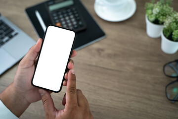 Poster - Top view Mockup image hand using a smartphone man Holding Cell Phone With Blank Screen