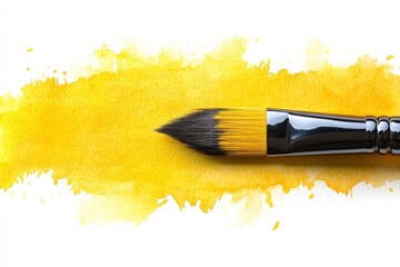 Aufkleber - Bright yellow paint brush resting on vibrant watercolor background in an artist's workspace