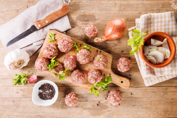 Wall Mural - raw meatball with herb on wooden board