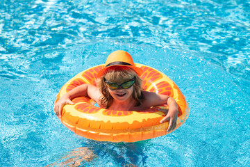 Wall Mural - Child playing in swimming pool. Summer vacation concept. Summer kids portrait in sea water on beach.