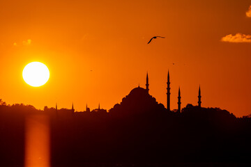 Wall Mural - suleymaniye mosque and sun at sunset. visit istanbul background photo
