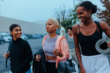 Group of smiling women walking together after fitness class