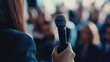 © mahamad - A journalist with a microphone engaging with the audience at a press conference.