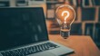© Amigo - Bright idea concept over laptop with question mark symbolizing innovation and brainstorming