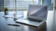 © chaiwat - Sleek modern laptop computer sitting on a silver desk with a few scattered papers and pens, minimalist decor, productivity, workspace, office setup