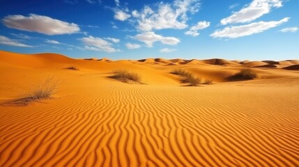 Aufkleber - Golden sand dunes stretch across a vast desert landscape under a bright blue sky with scattered clouds