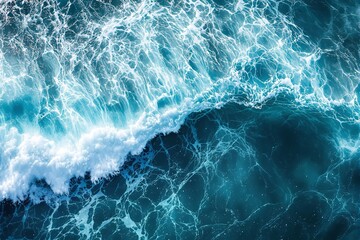 Poster - Ocean waves crashing with foam and light reflections, creating a mesmerizing pattern on the dark blue sea background.