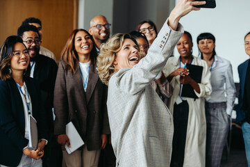 Wall Mural - team gathering for a joyful photo as coworkers capture a memorable moment together during a break at
