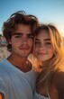 © yevgeniya131988 - Young couple taking selfie at beach during sunset, smiling and in love