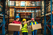 © Davor - Warehouse workers carrying boxes while supervisor giving instructions in storage facility