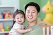 © Sandor - Portrait of happy father holding his smiling baby daughter in a bright playroom, enjoying quality family time
