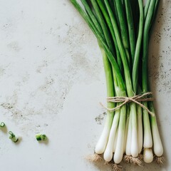 Poster - Fresh green scallions tied together on a textured surface depicting natural simplicity and culinary potential