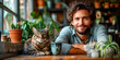 © Paul - Imagen de un joven hombre atractivo sentado mientras bebe café y a un lado un gato