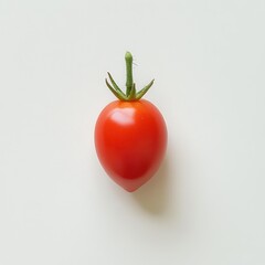 Poster - Fresh grape tomato resting on a light surface showcasing its vibrant red color and glossy sheen
