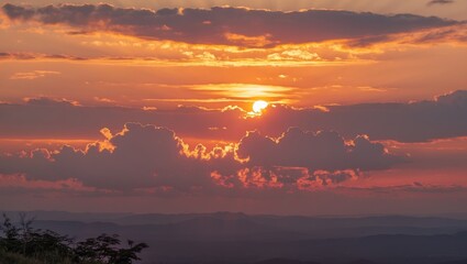 Wall Mural - a breathtaking sunset illuminating the sky with vibrant hues of gold, orange, and pink as day transi