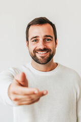 Indoor studio portrait friendly man providing close-up support and help