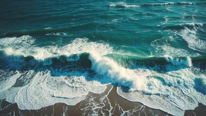 Poster - Aerial view of ocean waves crashing onto sandy shore creating dynamic patterns in turquoise water capturing the beauty of nature's rhythm