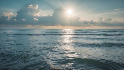Poster - Serene seascape with gentle waves and bright sunlight streaming through clouds over tranquil ocean waters at dawn.