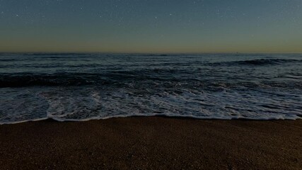 Wall Mural - waves crashing against the seashore at night