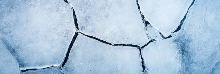 Poster - Ice floes creating a natural geometric pattern on the surface of a frozen lake, highlighting the effects of cold weather and creating a beautiful winter landscape