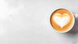 Latte art heart, coffee cup, marble table, morning beverage