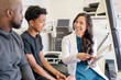 © Cavan Images - Doctor showing patients information on tablet
