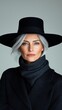 © Marina Varnava - Old female magician with silver hair exuding mystery against a clean white background